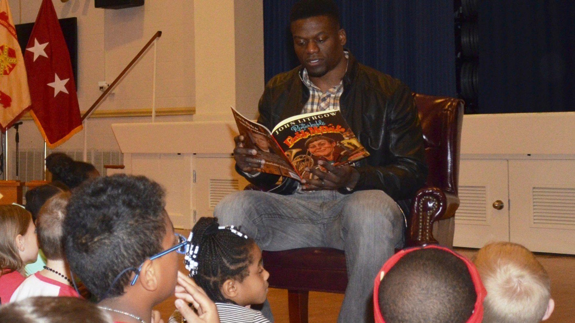 Benjamin Watson reading to children