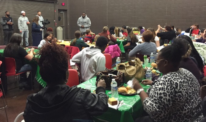 Walker speaking to members of the community center