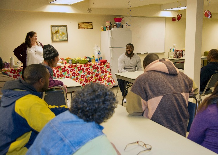 Hayes sitting, speaking to a group at the Hayes Foundation