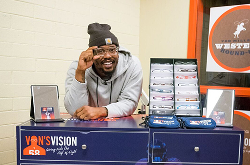 Von Miller leaning on a table for Von's Vision