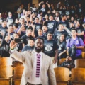 Justin Tuck taking a selfie with students.